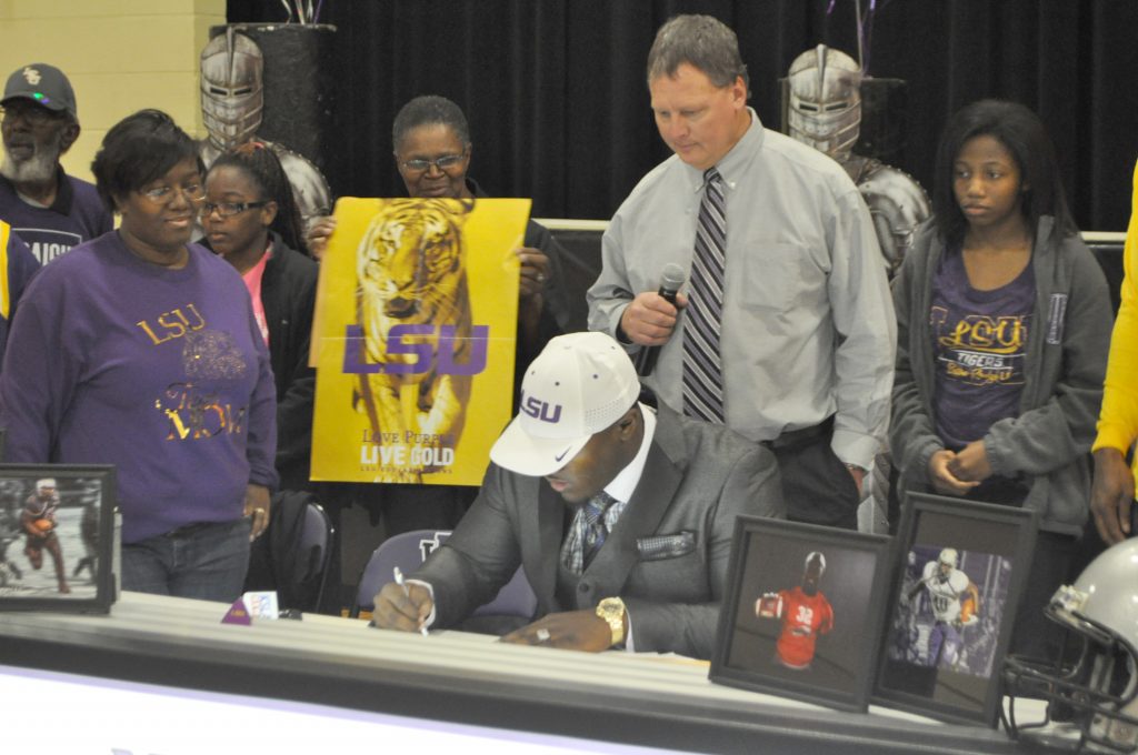 North Webster’s highly-recruited running back Devin White made his intentions to attend Louisiana State University known at a school-wide assembly Friday. Above, White signs his letter of intent to play for the LSU Tigers. Blake Banch/Press-Herald